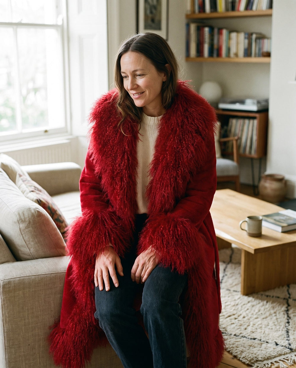 The Ember coat worn open over a cream knit indoors, faux fur shawl collar, Fox & Ocean